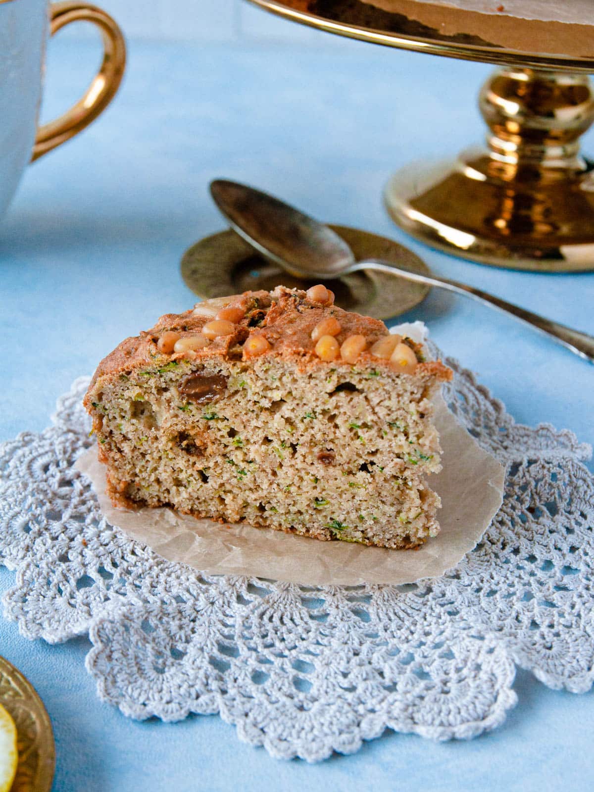 A slice of gluten-free zucchini cake on a glass plate.